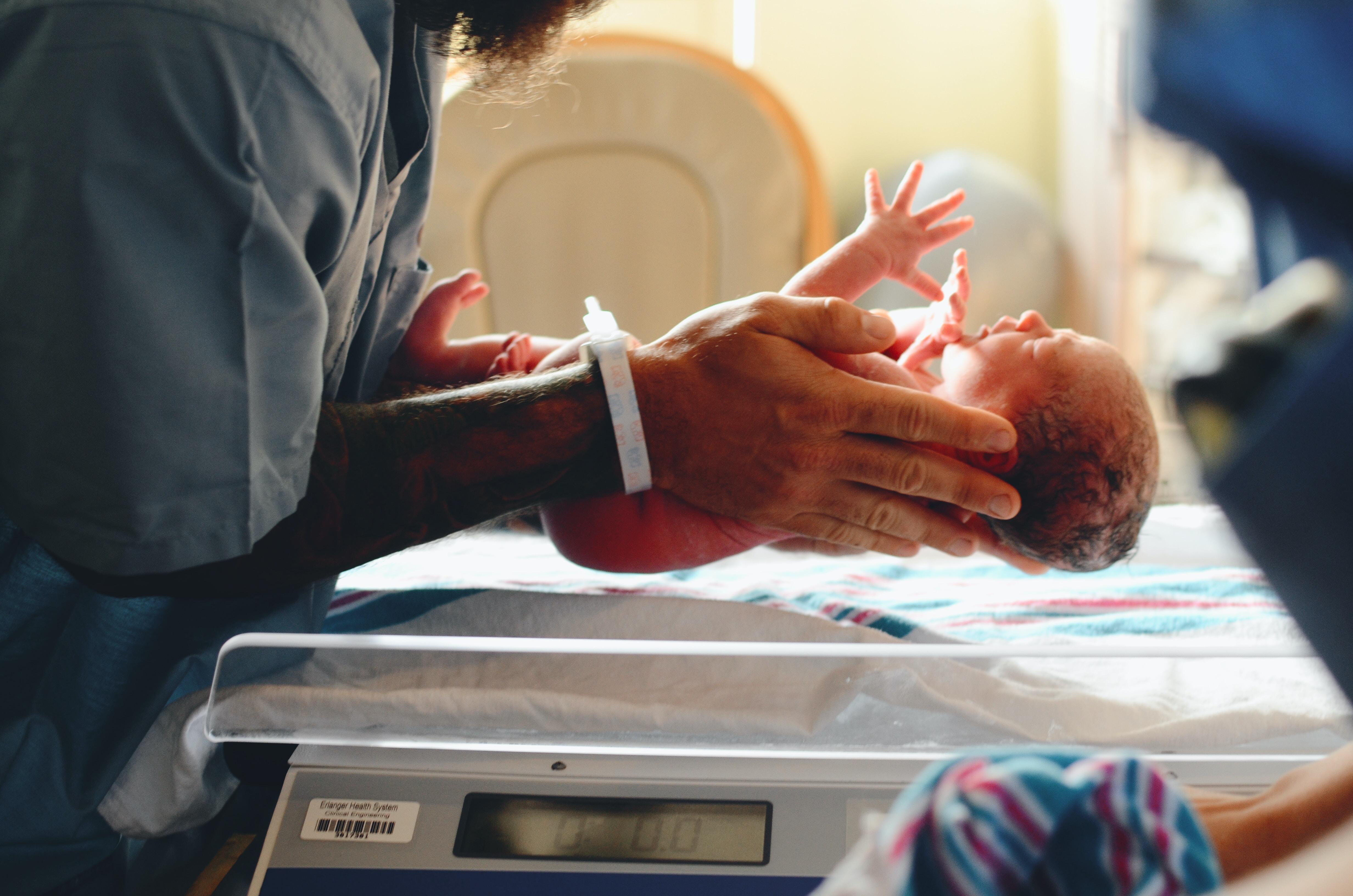 newborn baby cradled in the hospital